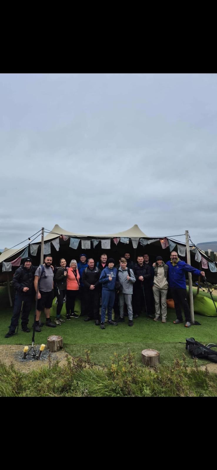 The group under the tent after a hike